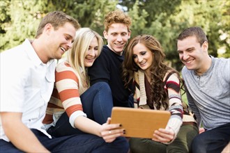 Group of friends looking at digital tablet