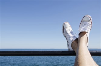 Man's feet on ferry boat