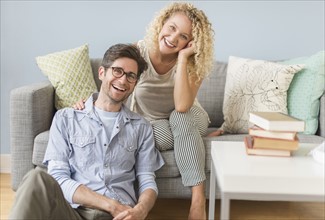 Portrait of couple in living room.