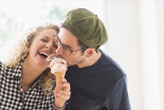 Couple eating ice cream together.