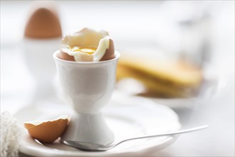 Close up of soft boiled egg in egg cup.
