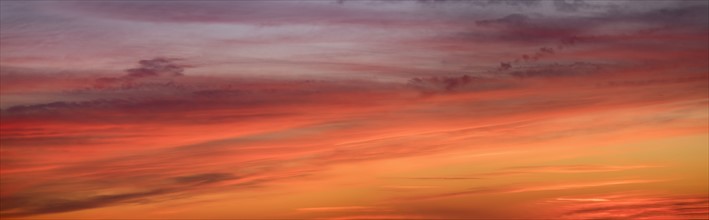 Panoramic view of sunrise sky with clouds.