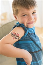 Portrait of boy (6-7) with tatoo on shoulder