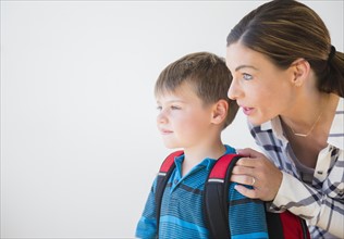 Mother preparing son (6-7) for school