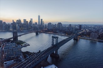 Lower Manhattan, View of Brooklyn Bridge and One World Trade Center at dusk