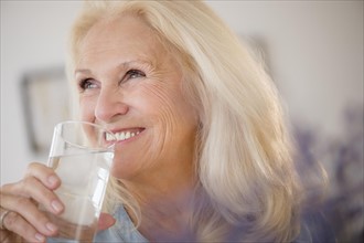 Portrait of senior woman drinking water