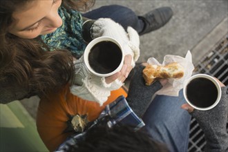 Directly above view of couple drinking coffee