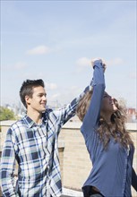 Young couple dancing on roof