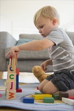 Boy (2-3) playing with blocks in living room