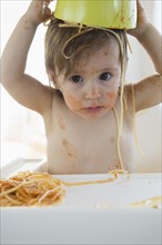 Girl (2-3) eating spaghetti