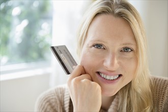 Portrait of woman holding credit card