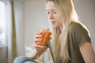 Woman drinking carrot juice