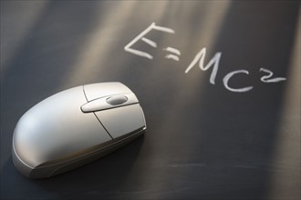 Computer mouse on blackboard