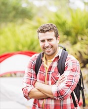 Portrait of man in front of tent with backpack
