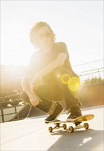 Man crouching on skateboard
