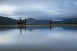 Scenic view of lake and hills at dawn