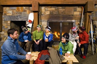 Group of skiers hanging out at fireplace