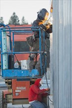 Men welding steel bar
