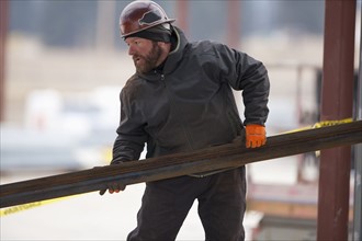 Man lifting steel bar