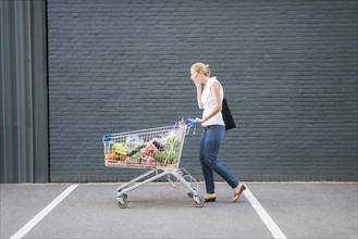 Woman walking with shopping cart