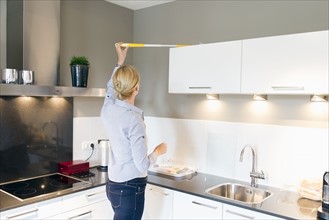 Woman cleaning kitchen