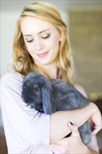 Young woman holding bunny