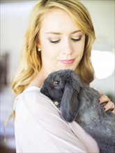 Young woman stroking her bunny