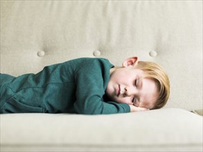 Boy (2-3) sleeping on sofa
