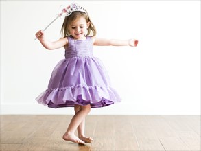 Girl (4-5) in princess costume dancing