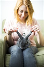 Woman touching rabbit's ears
