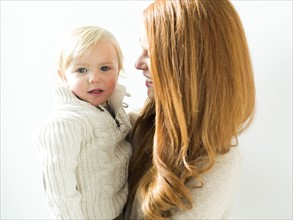 Smiling mother holding son (2-3)