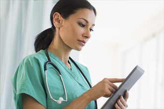 Female doctor using digital tablet.