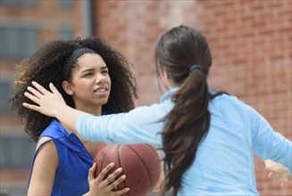 Teenage girls (14-15, 16-17) playing basketball.