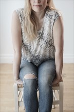Low-section of woman wearing torn jeans.