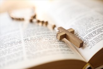 Rosary beads in open Bible.
