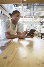 Bakery owner using digital tablet.