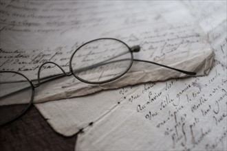 Antique eyeglasses and letters.