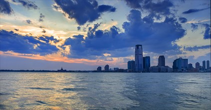 Waterfront cityscape at sunset. USA, New Jersey, Jersey City.