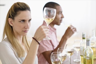 Man and woman tasting white wine.
