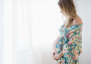 Pregnant woman in colorful dressing gown