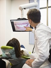 Dentist and patient looking at screen