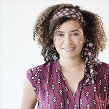 Portrait of smiling woman with curly hair.