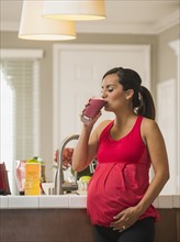 Portrait of pregnant woman drinking fruit cocktail