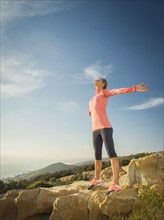 Woman in sportswear with outstretched arms