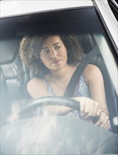 Young woman driving car.