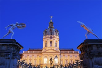 Charlottenburg Palace facade and entrance statues at night
