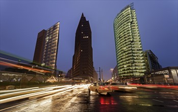 Illuminated skyscrapers and street traffic