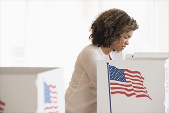 Young woman preparing voting booth.