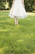 Woman in white dress standing on lawn
