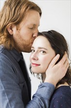 Man kissing young woman
